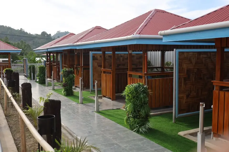 Bovotel timber accommodation along a landscaped path